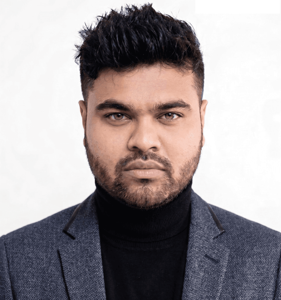 Professional portrait of Md. Amirul Islam, Chief Operating Officer of Level Up Strategy Limited, wearing a charcoal blazer and black turtleneck against a white background.